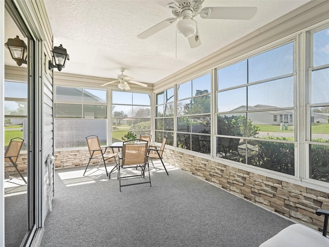 sunroom with plenty of natural light and ceiling fan