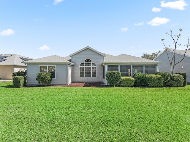 ranch-style home with a front yard and a sunroom