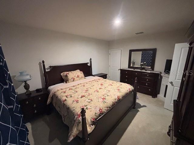 bedroom featuring light carpet and visible vents