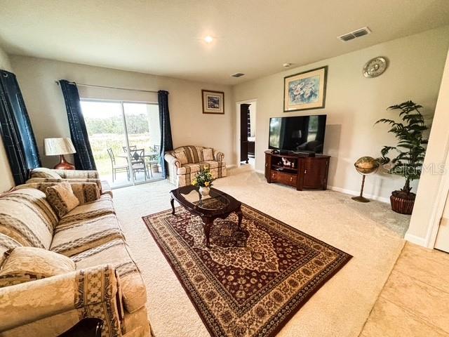 living area with visible vents and baseboards