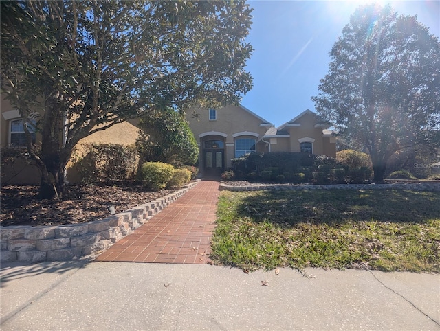 view of front of house featuring french doors and stucco siding