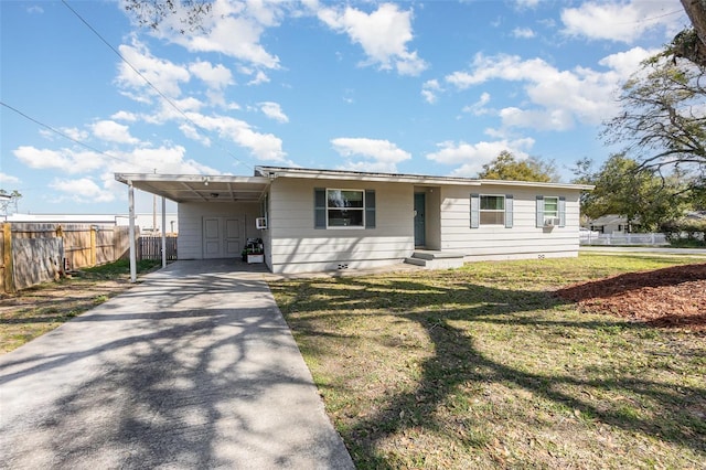 view of front of house with an attached carport, concrete driveway, fence, and a front yard