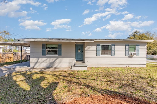 view of front of house with fence, a carport, cooling unit, driveway, and a front lawn