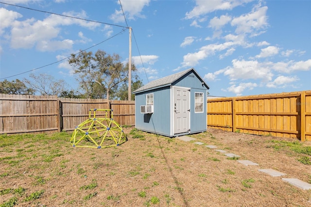 view of yard with an outbuilding, a storage unit, and a fenced backyard