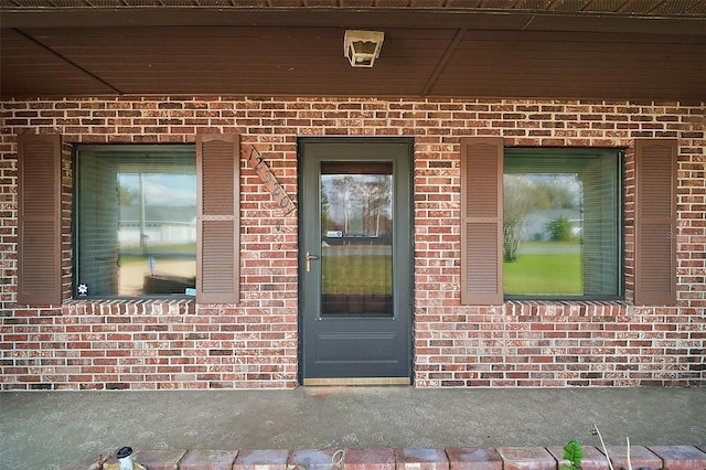 property entrance with brick siding