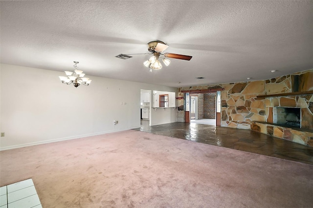 unfurnished living room featuring baseboards, a textured ceiling, carpet floors, a fireplace, and ceiling fan with notable chandelier