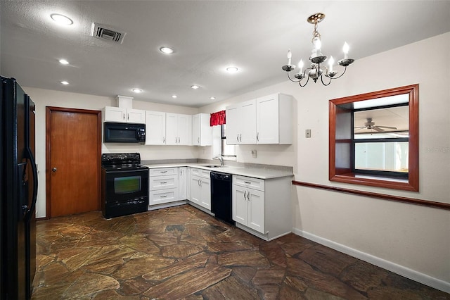 kitchen featuring baseboards, visible vents, white cabinets, black appliances, and a sink