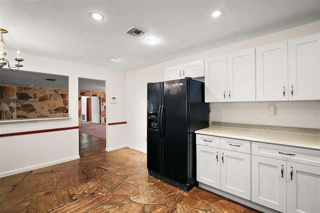 kitchen featuring recessed lighting, light countertops, visible vents, black refrigerator with ice dispenser, and white cabinetry