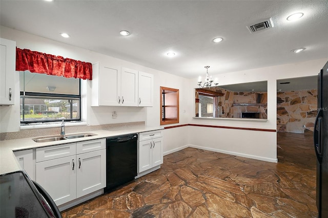 kitchen with black appliances, a sink, visible vents, and white cabinetry