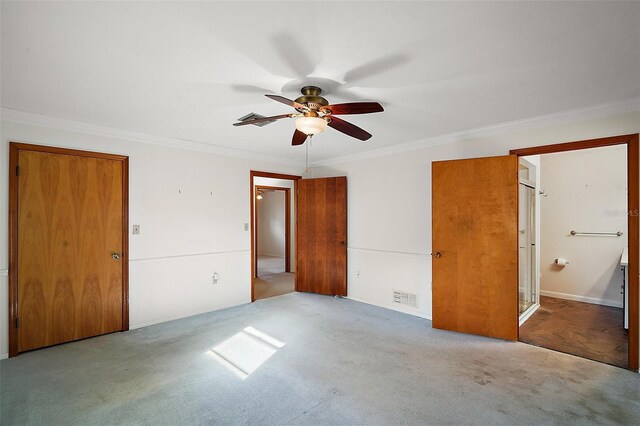 unfurnished bedroom with visible vents, ensuite bath, ceiling fan, ornamental molding, and carpet flooring