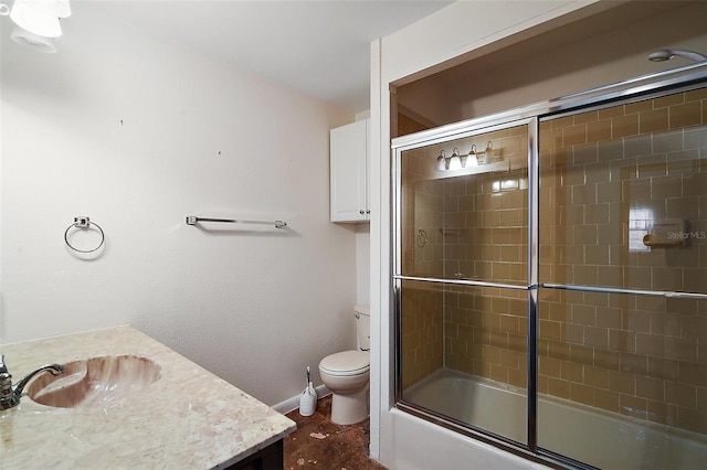 bathroom with combined bath / shower with glass door, vanity, toilet, and baseboards