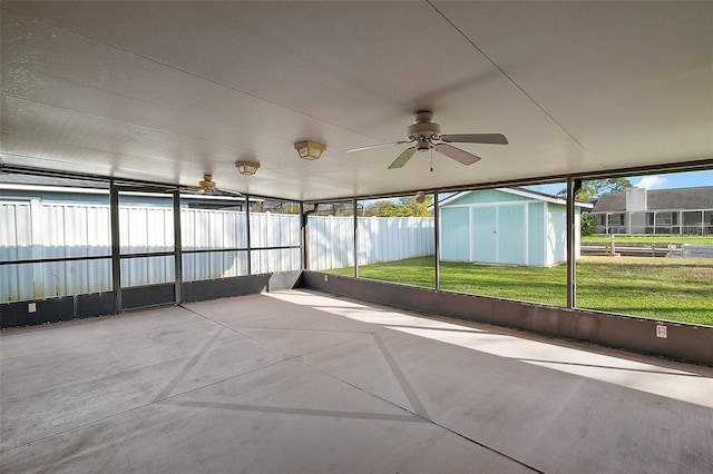 unfurnished sunroom featuring ceiling fan and a healthy amount of sunlight