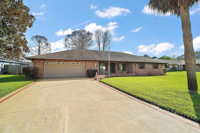 ranch-style home with concrete driveway, an attached garage, fence, a front yard, and brick siding