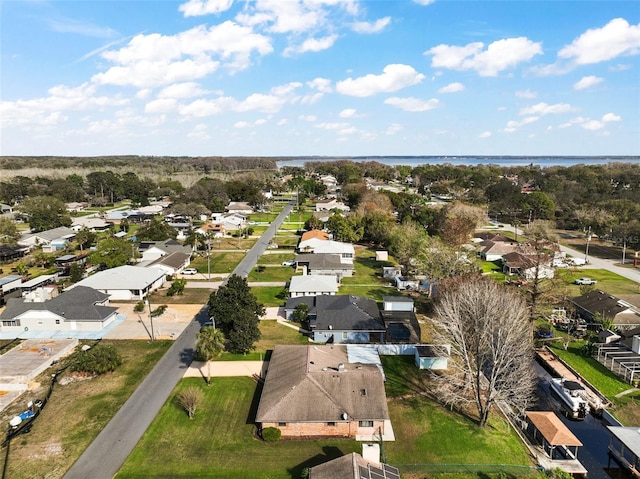 drone / aerial view with a water view and a residential view