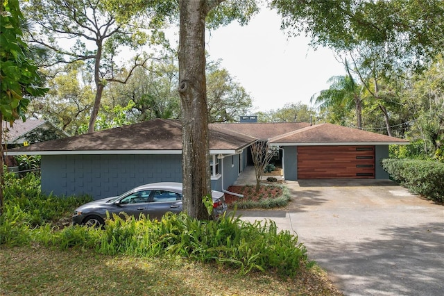 view of front of house featuring concrete driveway and an attached garage