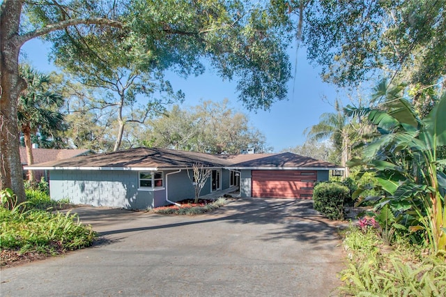 ranch-style house with driveway and an attached garage