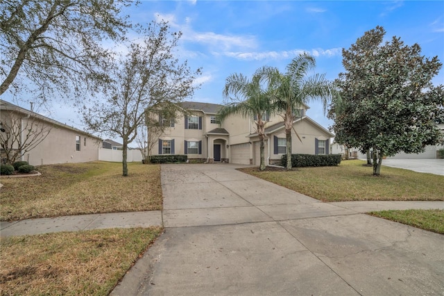 view of front of house featuring stucco siding, fence, a garage, driveway, and a front lawn