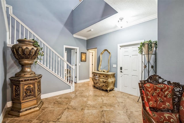 entryway with baseboards, stairs, and ornamental molding