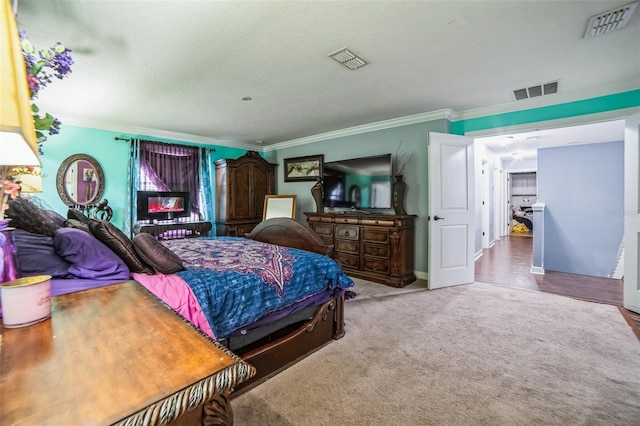 carpeted bedroom featuring visible vents and crown molding