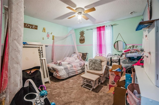 bedroom featuring a textured ceiling, ceiling fan, and carpet flooring