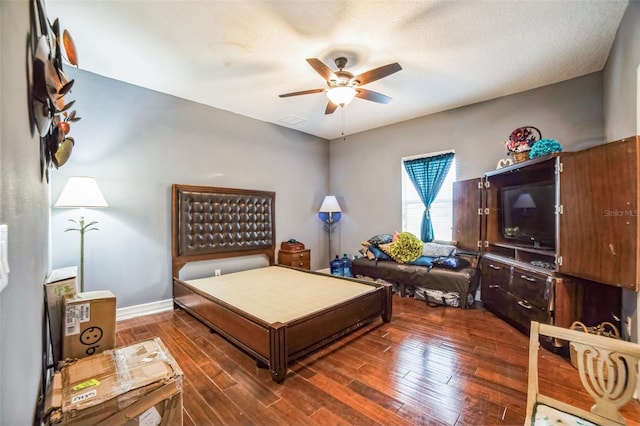 bedroom with visible vents, a ceiling fan, a textured ceiling, wood finished floors, and baseboards