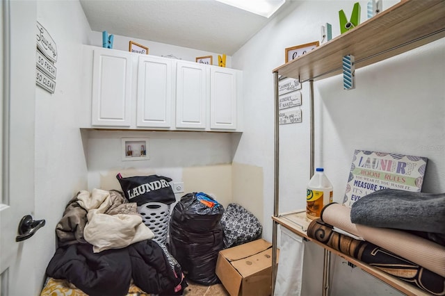 clothes washing area with hookup for a washing machine and cabinet space