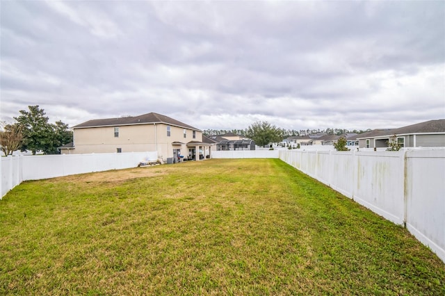 view of yard with a fenced backyard and a residential view