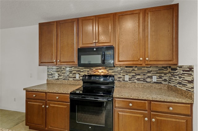 kitchen with black appliances, backsplash, and brown cabinets