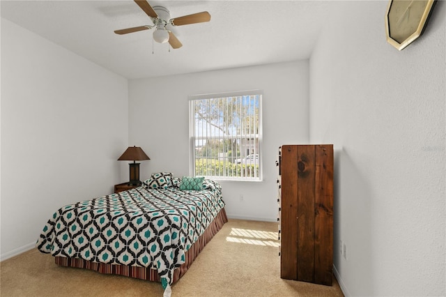 bedroom featuring carpet, baseboards, and a ceiling fan