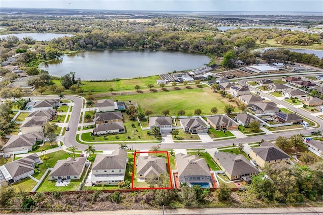 drone / aerial view with a water view and a residential view