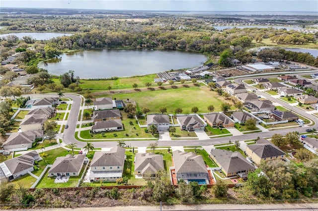 birds eye view of property featuring a water view and a residential view