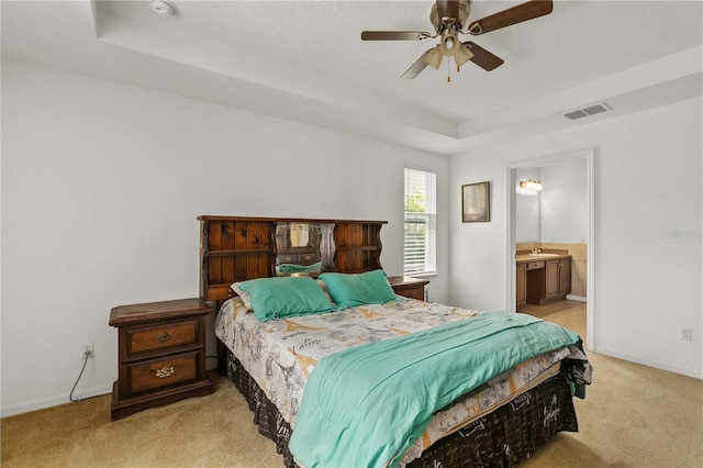 1841 Dunn Cove Dr, Apopka, FL 32703 - carpeted bedroom with a tray ceiling, baseboards, a sink, connected bathroom, and visible vents