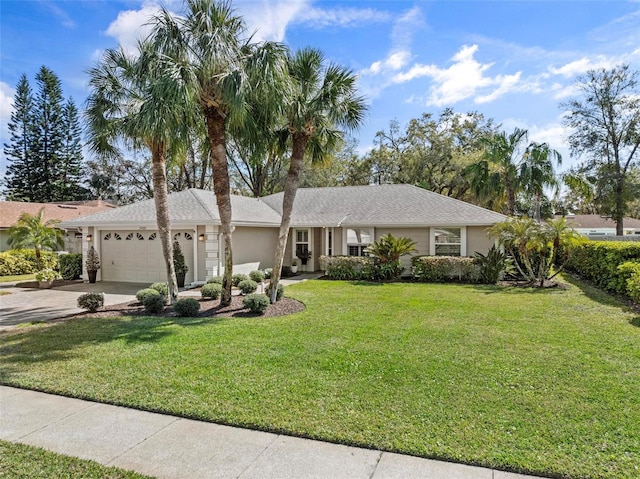 ranch-style house featuring a garage, driveway, a front yard, and stucco siding