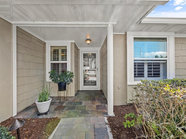 view of exterior entry with stucco siding