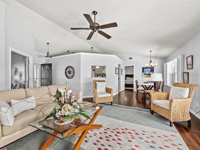 living room featuring lofted ceiling, a textured ceiling, wood finished floors, baseboards, and ceiling fan with notable chandelier