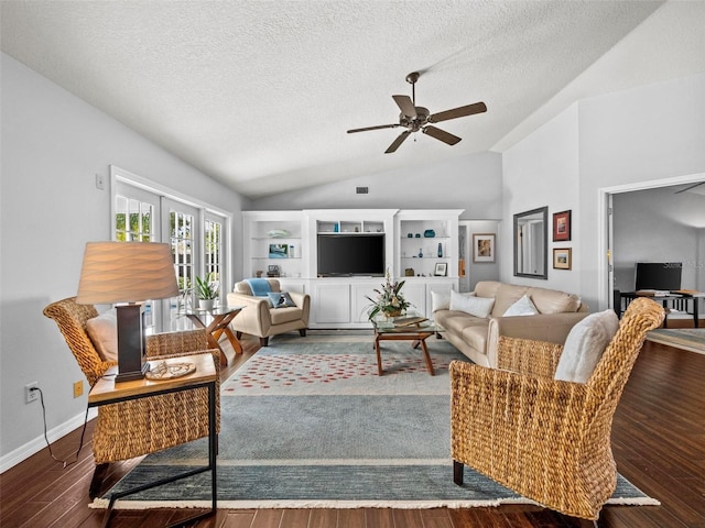 living room featuring lofted ceiling, a textured ceiling, wood finished floors, a ceiling fan, and baseboards