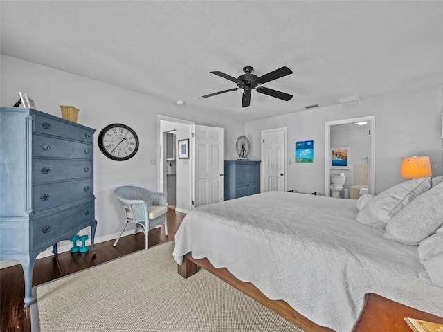 bedroom featuring a ceiling fan, wood finished floors, visible vents, and baseboards