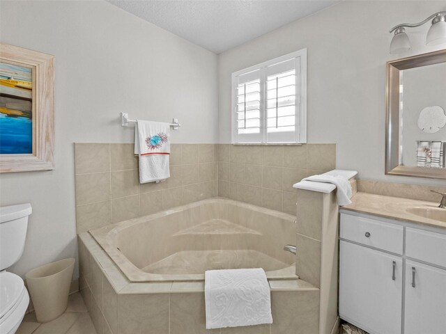 full bathroom with a bath, a textured ceiling, vanity, and toilet