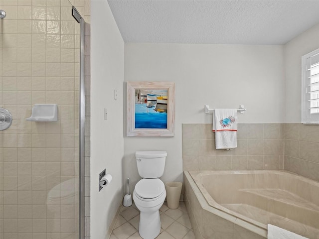 bathroom with tile patterned floors, toilet, a textured ceiling, a shower stall, and a bath