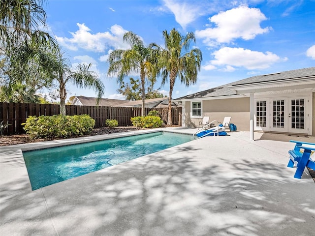 view of pool featuring a fenced in pool, french doors, a patio area, and a fenced backyard