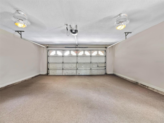 garage with a garage door opener and baseboards