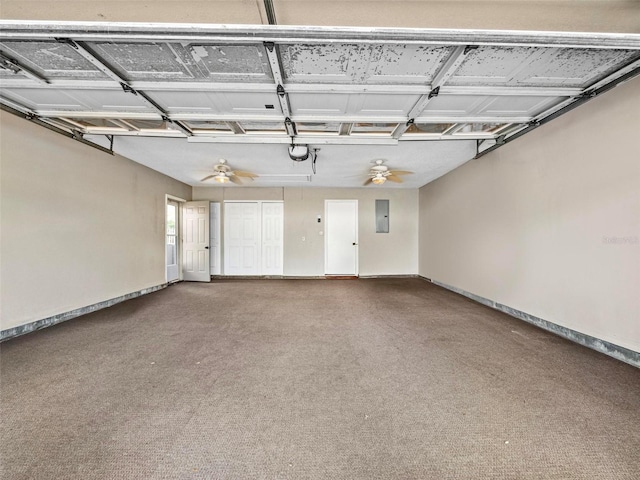 garage with ceiling fan, electric panel, and baseboards