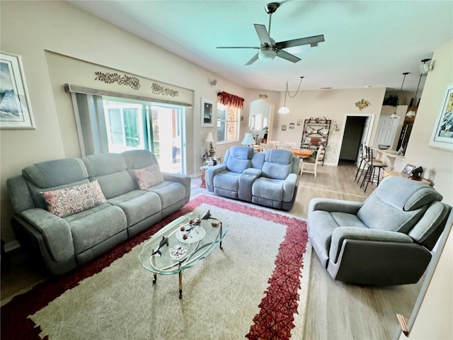 living room featuring wood finished floors and a ceiling fan