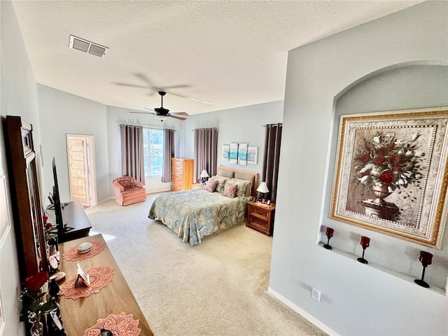 bedroom with a ceiling fan, baseboards, visible vents, a textured ceiling, and carpet flooring