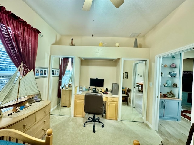 office featuring plenty of natural light, light carpet, ceiling fan, and vaulted ceiling