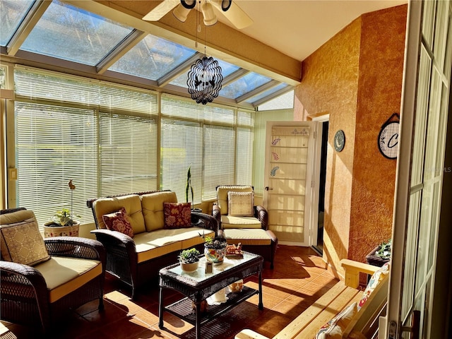 sunroom featuring lofted ceiling with skylight and ceiling fan