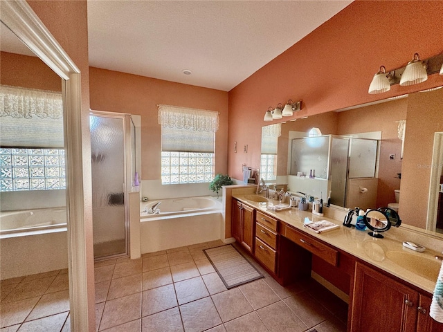 bathroom with double vanity, a stall shower, a sink, tile patterned flooring, and a bath