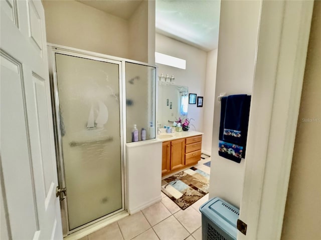 bathroom featuring tile patterned floors, a stall shower, and vanity