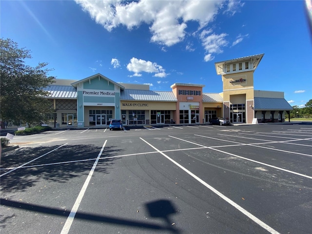 view of building exterior with uncovered parking