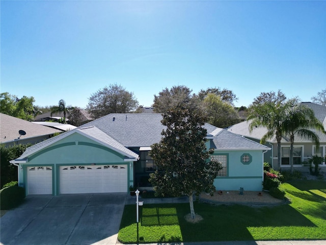 ranch-style house with a front yard, concrete driveway, a garage, and stucco siding